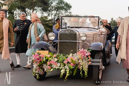 Photo of Grooms entry in a vintage car