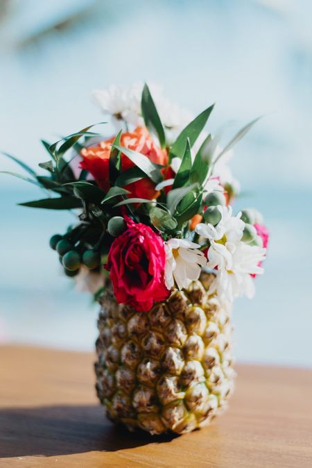 Tropical theme centrepiece with pineapple and flowers