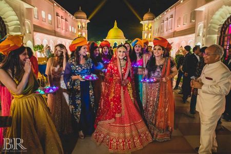 Photo of Bride entering with bridesmaids holding LED thalis