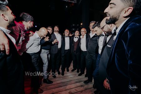 Photo of A candid and fun groomsmen photo on the sangeet night