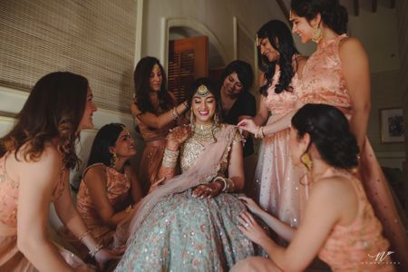 Matching bridesmaids in peach with bride 