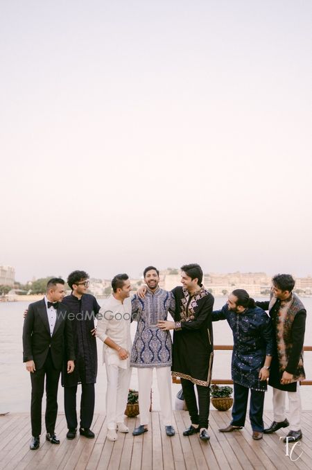 Photo of Candid capture of the groom in a blue sherwani with his groomsmen
