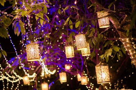Photo of Romantic lighting with lanterns hanging from trees