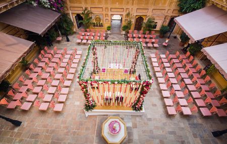 Photo of mandap seating ideas with pink chairs around for seating