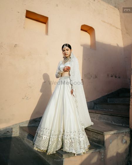 Photo of bride in white lehenga
