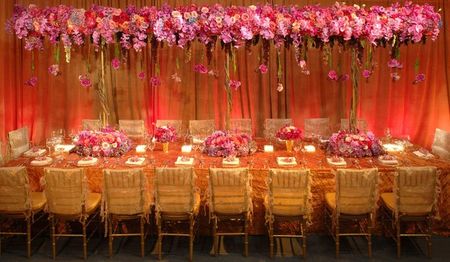 Pink and gold theme table setting with floral canopy