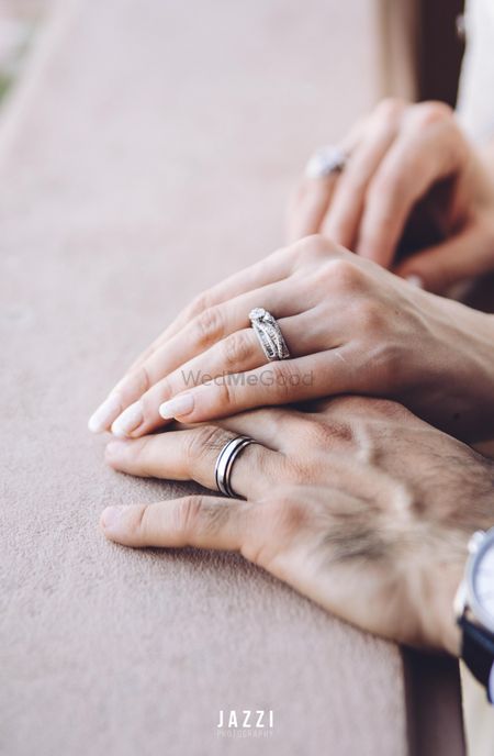 Photo of His and her hands with engagement rings