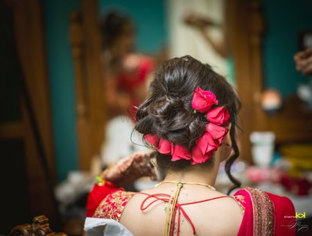 Photo of Bridal bun with red roses