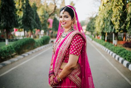 Contrasting jewellery in green with fuchsia lehenga 