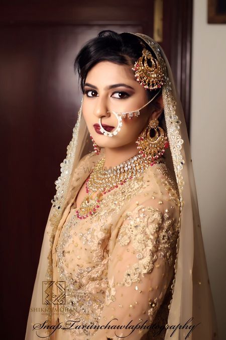 Photo of Bridal potrait of bride in gold jewellery and lehenga