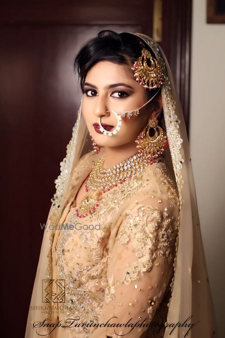 Photo of Bridal potrait of bride in gold jewellery and lehenga