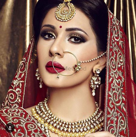 Red and gold bridal makeup with smokey eye