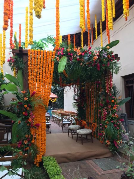 Entrance decor done with marigold garlands, lush greens and other flowers.