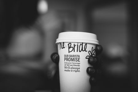 Photo of Bride holding coffee cup with name