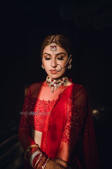 Bride dressed in a red lehenga on her wedding day.