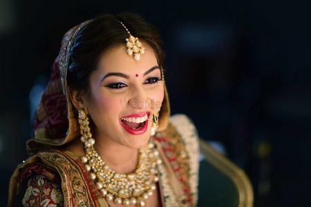 Photo of Happy bride wearing bright red lipstick