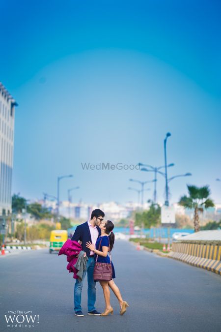 Couple kissing in middle of the road shot