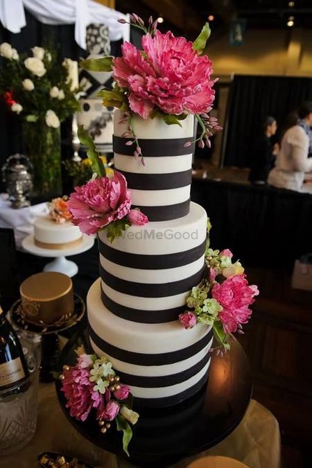 Black and white striped cake with pink flowers