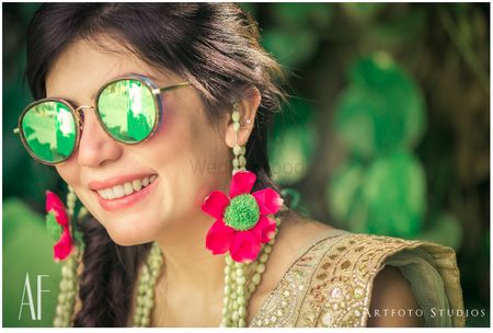 Photo of Bride in green reflector sunglasses on mehendi