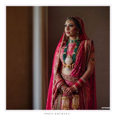 Red lehenga with green jewellery with beads 