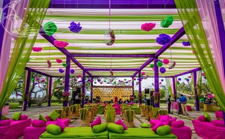 Photo of Colourful mehendi decor with hanging paper lamps
