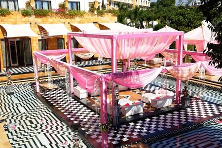 Photo of Pastel Pink mandap decor on checkerboard flooring