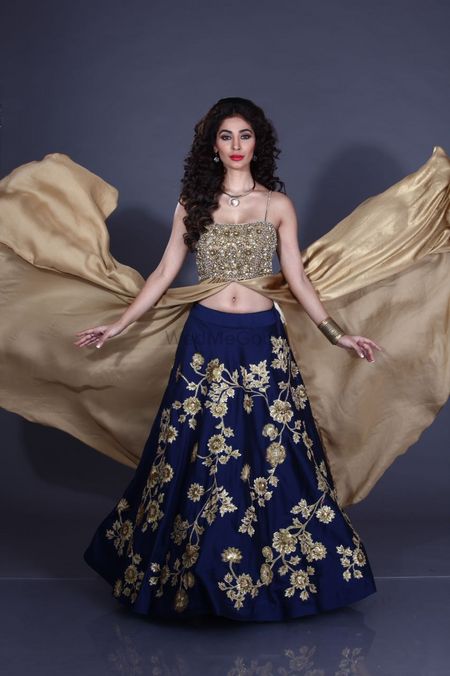 Navy blue lehenga with floral embroidery and gold blouse