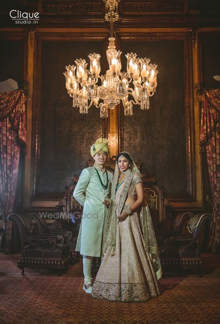 Coordinated bride and groom in mint and grey outfits