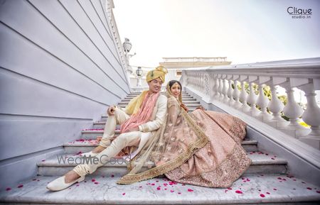 Coordinated bride and groom in light pink outfits