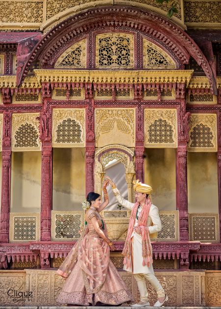 Destination wedding couple portrait at palace in coordinated outfits
