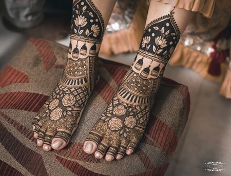 Photo of Bridal feet mehndi design with intricate designs.