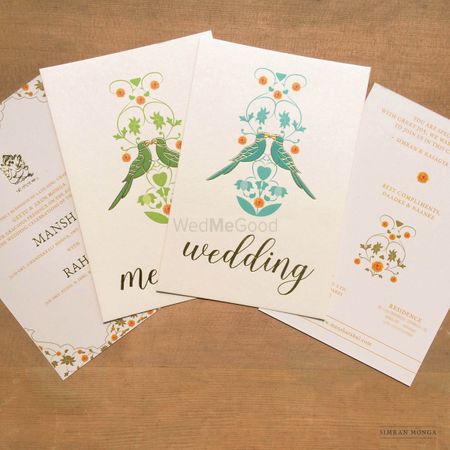 Photo of Simple white wedding card with bird motifs