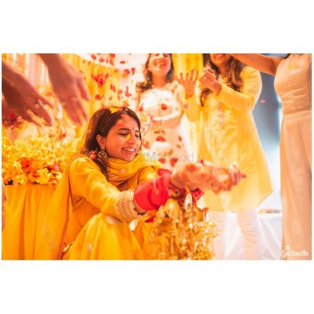 Photo of A bride caught in a happy moment on Haldi ceremony.