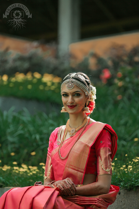 Photo of South Indian bride wearing silver mathapatti and red saree
