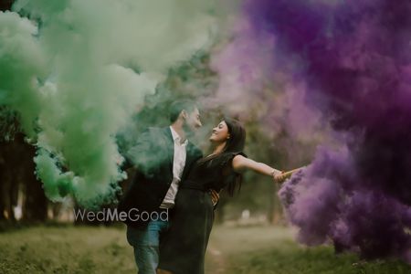 pre wedding shoot with couple holding smoke sticks 