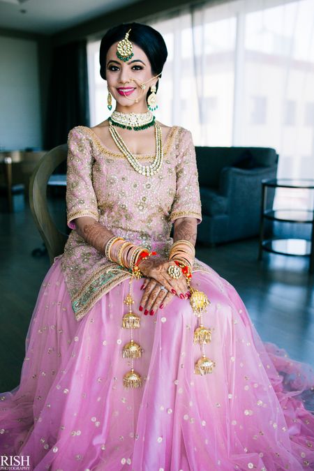 Bride in morning light pink lehenga with long blouse