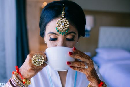 Bride drinking coffee shot before getting ready