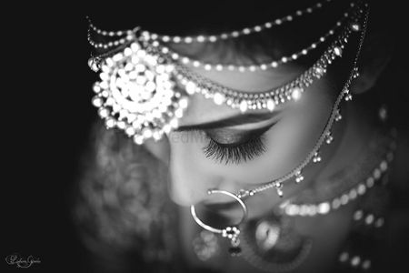 Black and whiye bridal portrait with statement maangtikka and nath