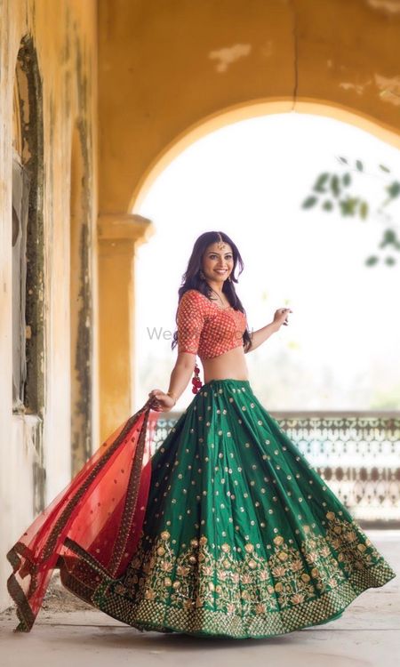 Photo of Dark green lehenga for mehendi with small motifs and red blouse and dupatta