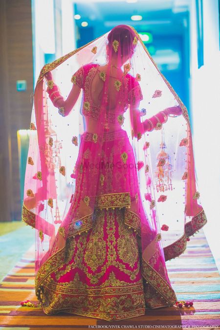 Photo of Bright pink and gold bridal lehenga