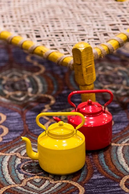 Red and yellow tea kettles in decor