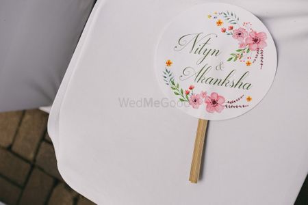 Hand fans on chairs for every guest 