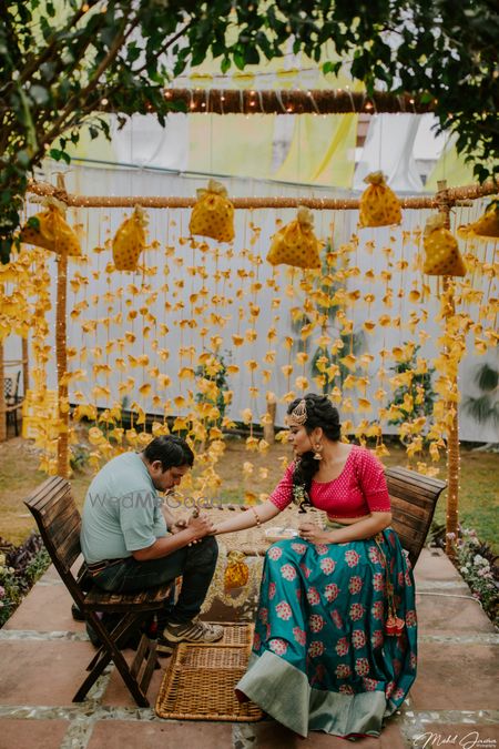 Mehendi decor with flowers and potlis 