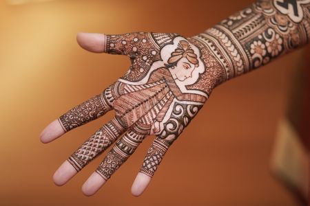 Hand mehndi with intricate design. 