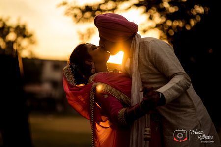 Couple kissing shot during sunset