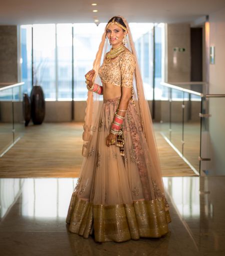Simple peach tulle lehenga with matching dupatta and heavy blouse