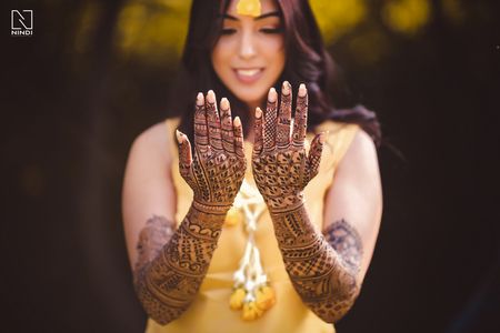 Bride showing off mehendi portrait 