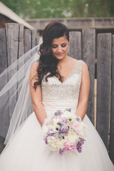 Grey and white wedding gown with lavender bouquet