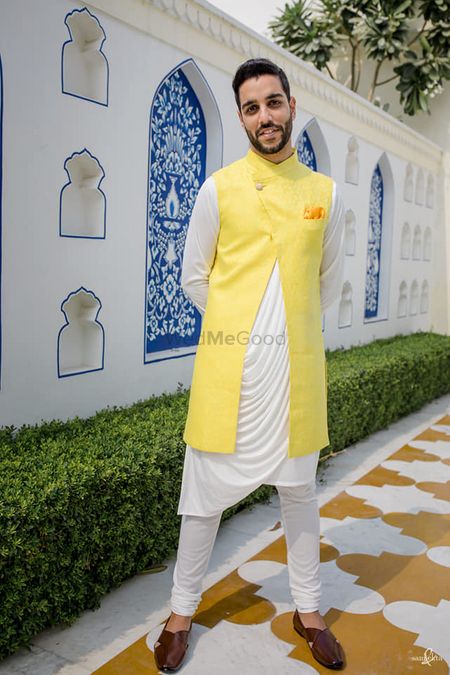 Groom wearing a cowled kurta with a front slit bandhgala.