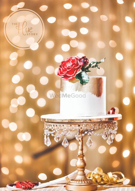Simple floral cake with gold foil on unique stand